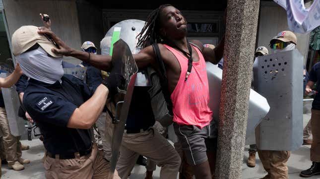 Charles Murrell, center, fends off a marcher from a group bearing insignias of the white supremacist group Patriot Front on July 2, 2022, in Boston. The Black musician who says members of the white nationalist hate group punched, kicked, and beat him with metal shields during a march through Boston in 2022 sued the organization on Tuesday, Aug. 8, 2023.