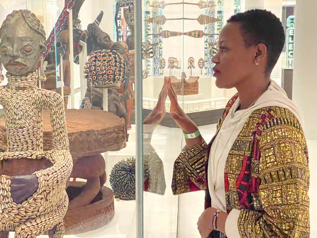 A woman stares at a statue