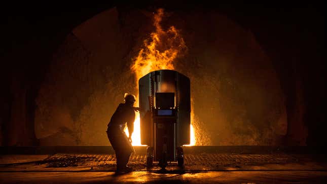 A worker tests the quality of molten iron at a steel furnace.