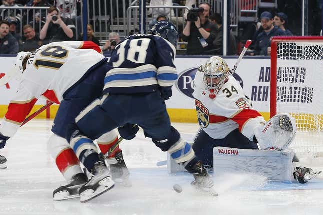 Apr 1, 2023; Columbus, Ohio, USA; Columbus Blue Jackets center Boone Jenner (38) tries to tip the puck against Florida Panthers defenseman Lucas Carlsson (32) during the second period at Nationwide Arena.
