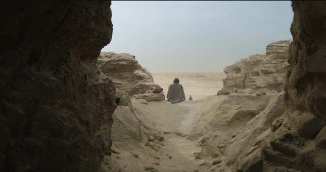 Obi wan sitting in the desert.