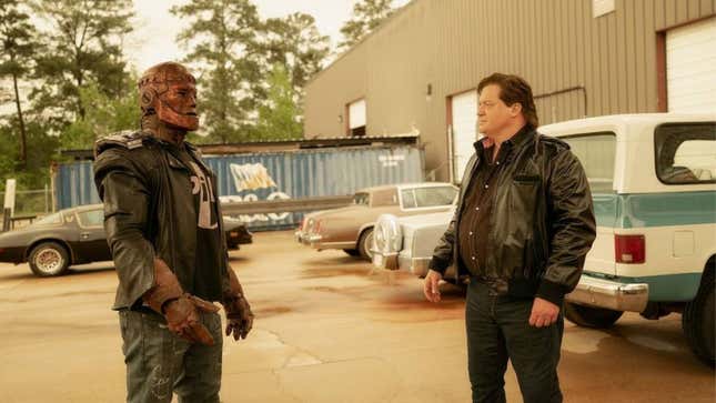 Robotman stares at Cliff Steele, his former human self, in a 1980s parking lot.