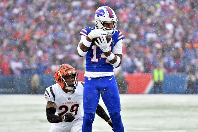 Jan 22, 2023; Orchard Park, New York, USA; Buffalo Bills wide receiver Stefon Diggs (14) makes a catch while defended by Cincinnati Bengals cornerback Cam Taylor-Britt (29) during the first quarter of an AFC divisional round game at Highmark Stadium.