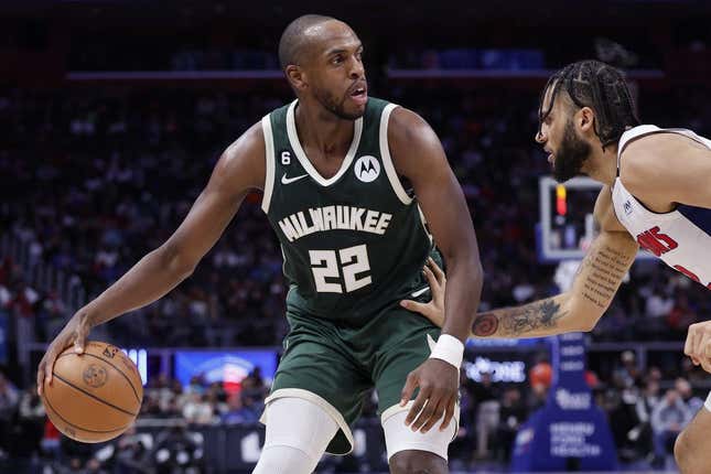 Mar 27, 2023; Detroit, Michigan, USA;  Milwaukee Bucks forward Khris Middleton (22) dribbles defended by Detroit Pistons forward Isaiah Livers (12) in the second half at Little Caesars Arena.