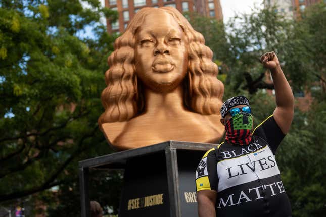 NEW YORK, NEW YORK - SEPTEMBER 30: Jason Woody from California raises his fist while posing in front of the “BREONNA TAYLOR” sculpture duringConfront Art’s Exhibition SEEINJUSTICE in Union Square on September 30, 2021 in New York City.