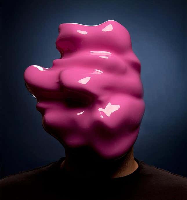A man wearing a pink blob mask.