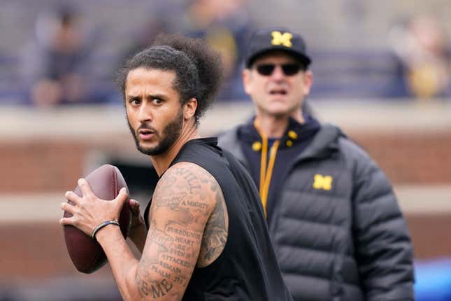 Michigan head football coach Jim Harbaugh watches as former NFL quarterback Colin Kaepernick throws during halftime of an NCAA college football intra-squad spring game, Saturday, April 2, 2022, in Ann Arbor, Mich.