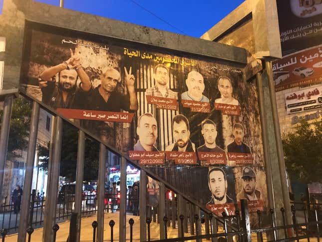 A banner featuring Palestinian activists in Bethlehem.