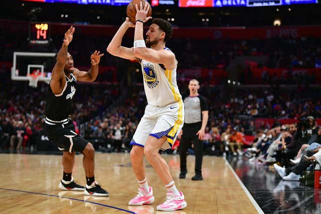 Feb 14, 2023; Los Angeles, California, USA; Golden State Warriors guard Klay Thompson (11) shoots against Los Angeles Clippers forward Kawhi Leonard (2) during the second half at Crypto.com Arena.