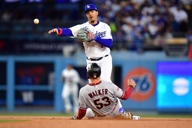 Mar 30, 2023; Los Angeles, California, USA; Arizona Diamondbacks first baseman Christian Walker (53) is out at second as Los Angeles Dodgers second baseman Miguel Vargas (17) throws to first for the out against third baseman Evan Longoria (3) during the first inning at Dodger Stadium.