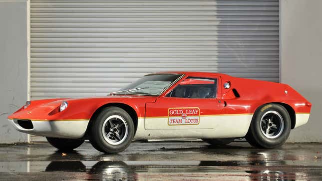 A photo of a red and white Lotus Europa sports car. 