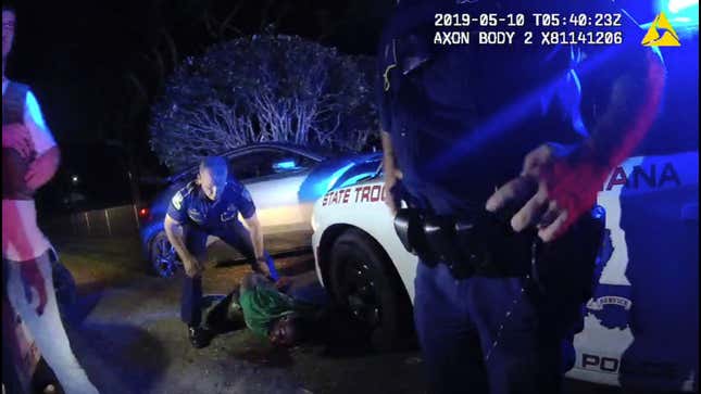 In this image from the body video camera of Louisiana State Police Lt. John Clary, Trooper Kory York stands over Ronald Greene, lying on his stomach, outside of Monroe, La., on May 10, 2019. Videos of the incident, obtained by The Associated Press, show Louisiana state troopers stunning, punching and dragging the Black man as he apologizes for leading them on a high-speed chase.