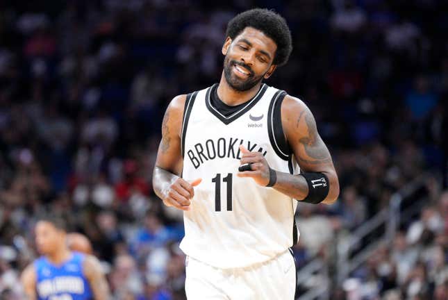 Kyrie Irving #11 of the Brooklyn Nets reacts after scoring against the Orlando Magic in the second half at Amway Center on March 15, 2022 in Orlando, Florida.