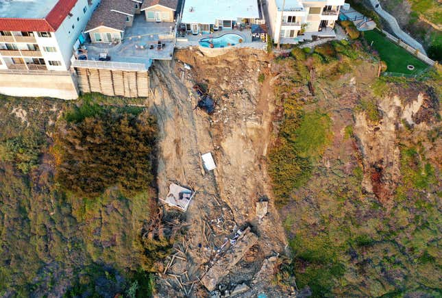 An aerial view of a remaining pool at the edge of a hillside landslide brought on by heavy rains, which caused four ocean view apartment buildings to be evacuated and shuttered due to unstable conditions, on March 16, 2023 in San Clemente, California.