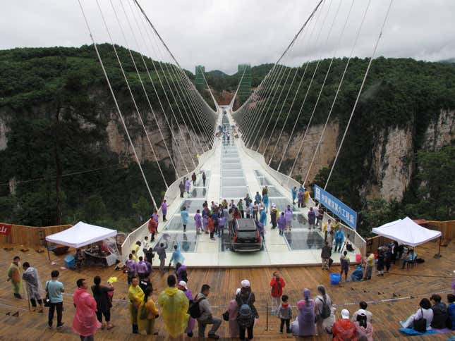 Image for article titled A terrifying aerial photo of thrill-seekers testing China’s newest cliffside glass walkway