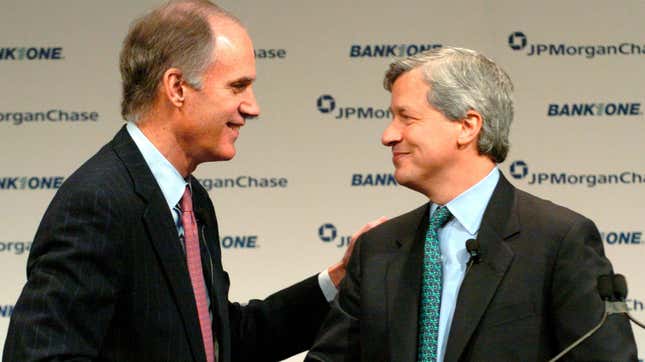 JP Morgan CEO William Harrison at left shakes hands with Bank One CEO Jamie Dimon at a news conference announcing their banks' merger in 2004