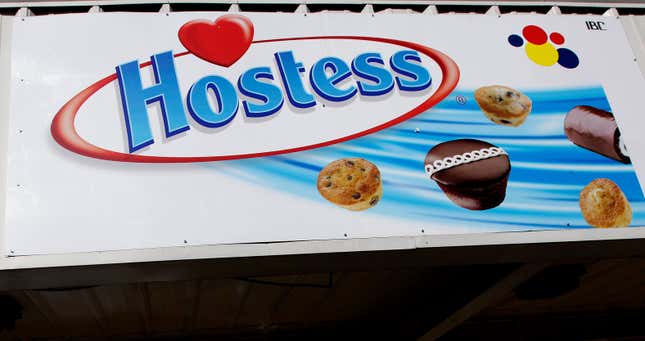 FILE - A Hostess sign is shown on a closed retail outlet store in Garland, Texas, Jan. 11, 2012. Hostess, the maker of snack classics like Twinkies and HoHos, is being sold to J.M. Smucker in a cash-and-stock deal worth about $5.6 billion. Smucker, which makes everything from coffee to peanut butter and jelly, will pay $34.25 per share in cash and stock, and it will also pick up approximately $900 million in net debt. (AP Photo/LM Otero, file)