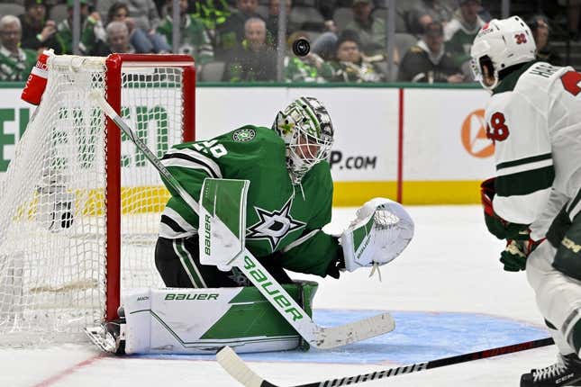 Apr 17, 2023; Dallas, Texas, USA; Dallas Stars goaltender Jake Oettinger (29) turns aside a shot by Minnesota Wild right wing Ryan Hartman (38) during the second overtime period in game one of the first round of the 2023 Stanley Cup Playoffs at the American Airlines Center.
