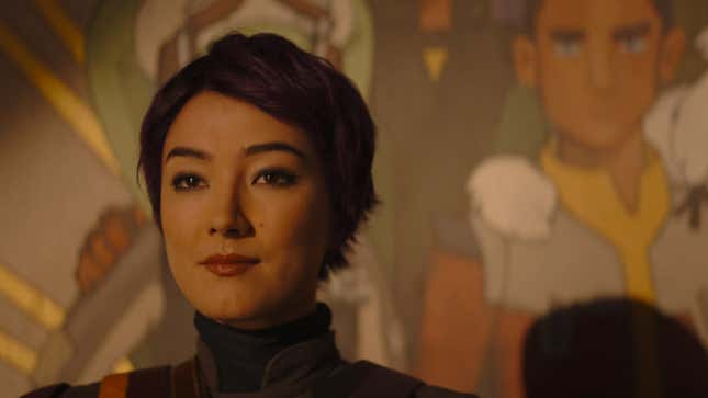 Sabine Wren stands in front of the mural she painted.
