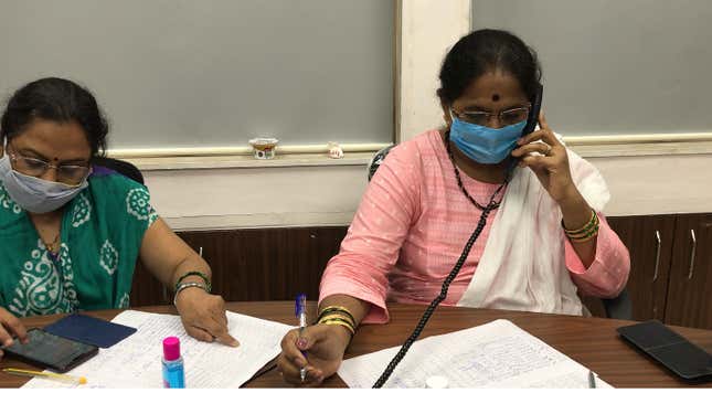 Staff attend phone calls inside the war room.