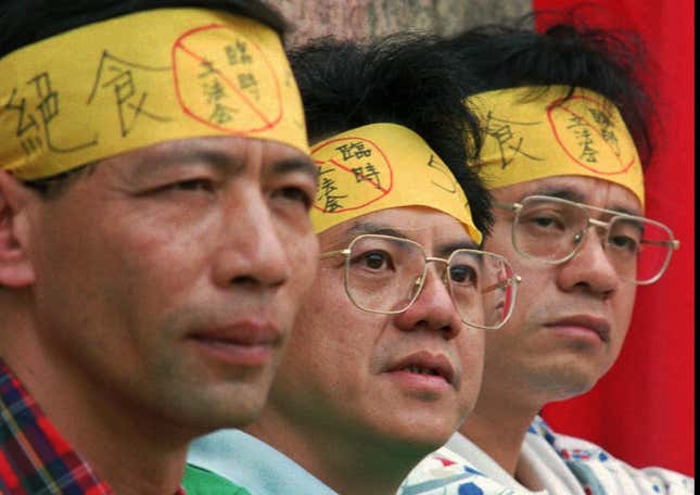 Three of the nine democracy campaigners, including legislator Yum Sin-ling, middle, stage a 50-hour hunger strike Tuesday, April 16, 1996, outside the building of Xinhua, China's unofficial embassy in Hong Kong, to protest Beijing's plans to replace the British colony's elected legislature with an appointed body after 1997.