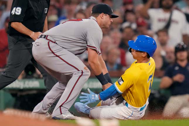 Atlanta Braves third baseman Austin Riley tags out Boston Red Sox's Masataka Yoshida for the third out of a triple play