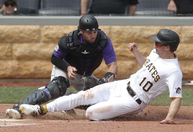 May 10, 2023; Pittsburgh, Pennsylvania, USA;  Colorado Rockies catcher Austin Wynns (16) tags Pittsburgh Pirates left fielder Bryan Reynolds (10) out at home plate attempting to score during the sixth inning at PNC Park.