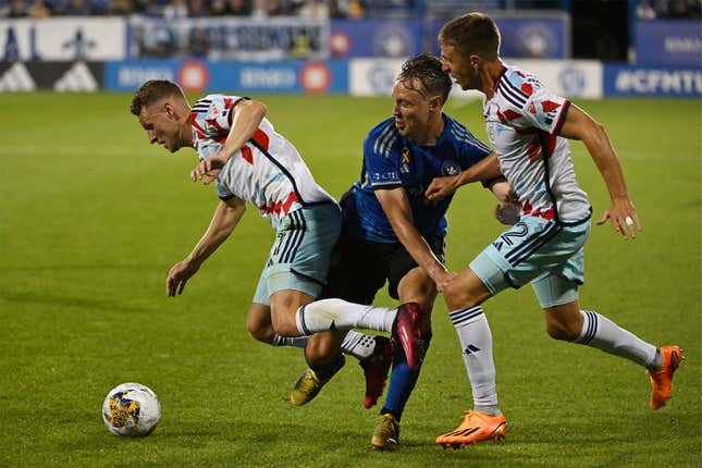 Sep 16, 2023; Montreal, Quebec, CAN; Chicago Fire forward Fabian Herbers (21) is tackled by CF Montreal midfielder Lassi Lappalainen (21) in the first half at Stade Saputo.