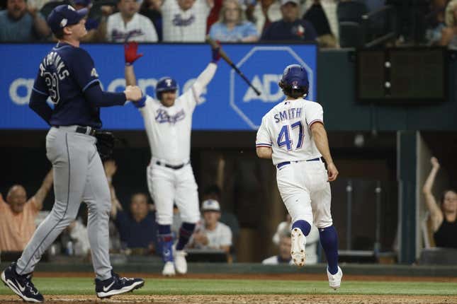 Jul 17, 2023; Arlington, Texas, USA; Texas Rangers shortstop Josh Smith (47) scores the winning run on a wild pitch in the ninth inning against the Tampa Bay Rays at Globe Life Field.