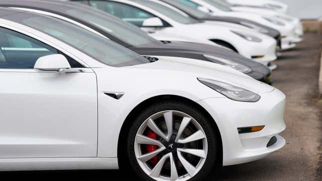 A long row of unsold 2021 Model 3 sedans sits at a Tesla dealership in this photograph taken Sunday, May 2, 2021, in Littleton, Colo.