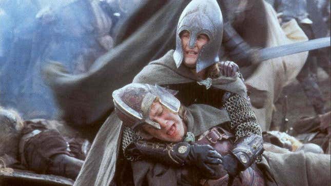 Pippin (Billy Boyd) cradles a gravely wounded Merry (Dominic Monaghan) in the aftermath of the Battle of Pelennor Fields.