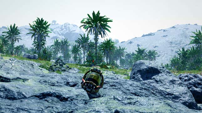 A lone helmet sits on the ground before some mountains.