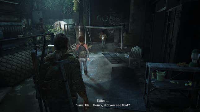 A screenshot from the game The Last of Us shows Joel looking on as Sam stands in a soccer goal holding a ball and Ellie faces him.