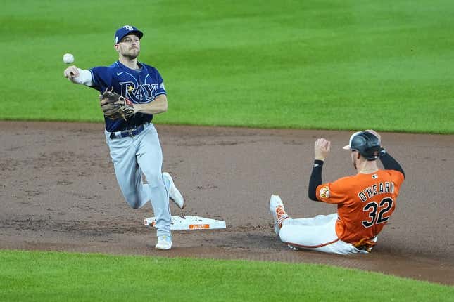 Sep 16, 2023; Baltimore, Maryland, USA;  Tampa Bay Rays second baseman Brandon Lowe (8) turns a double play with Baltimore Orioles first baseman Ryan O&#39;Hearn (32) sliding into second base during the first inning at Oriole Park at Camden Yards.