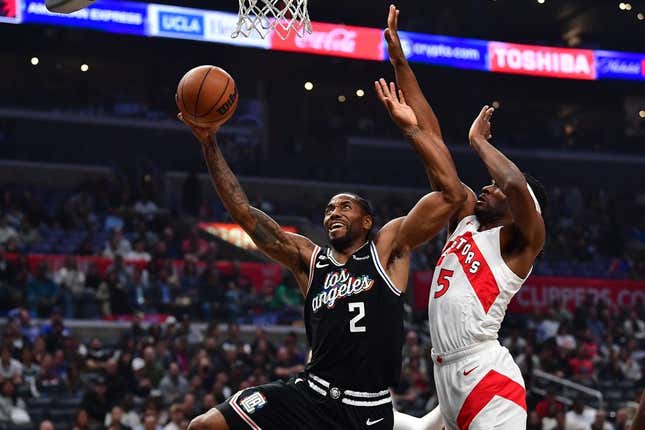 Mar 8, 2023; Los Angeles, California, USA; Los Angeles Clippers forward Kawhi Leonard (2) moves to the basket against Toronto Raptors forward Will Barton (5) during the first half at Crypto.com Arena.