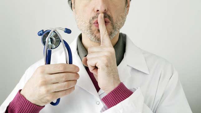 A doctor making the "shush" sign.