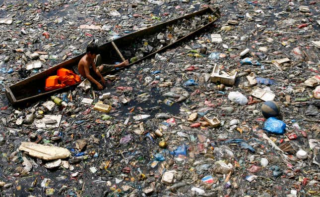 Elmer Comendador, 11, scavenges for plastic materials at a murky river in Mandaluyong City, east of Manila, Philippines, April 21, 2007.
