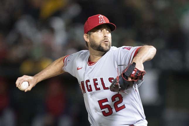 March 30, 2023; Oakland, California, USA; Los Angeles Angels relief pitcher Ryan Tepera (52) delivers a pitch against the Oakland Athletics during the eighth inning at RingCentral Coliseum.
