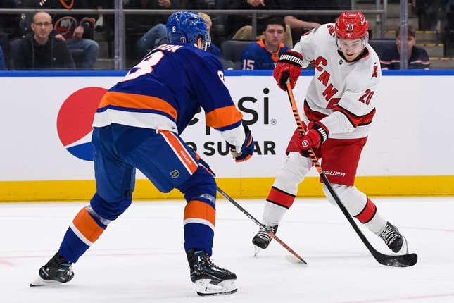 Apr 21, 2023; Elmont, New York, USA; Carolina Hurricanes center Sebastian Aho (20) attempts a shot defended by New York Islanders defenseman Noah Dobson (8) during the first period in game three of the first round of the 2023 Stanley Cup Playoffs at UBS Arena.