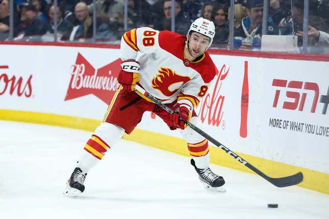Apr 5, 2023; Winnipeg, Manitoba, CAN;  Calgary Flames forward Andrew Mangiapane (88) looks to make a pass in the Winnipeg Jets zone during the first period at Canada Life Centre.