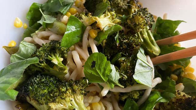 Noodles, broccoli, basil, and sweet corn with chopsticks