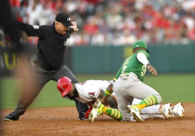 Apr 25, 2023; Anaheim, California, USA;  Second base umpire Mike Muchlinski calls Los Angeles Angels second baseman Luis Rengifo (2) safe on a stole base as he beats the tag by Oakland Athletics second baseman Tony Kemp (5) in the first inning at Angel Stadium.