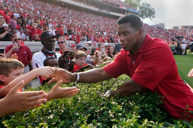 Former Georgia running back and Republican candidate for U.S. Senate, Herschel Walker greets fans at halftime of an NCAA college football game between Georgia and UAB, Saturday, Sept. 11, 2021, in Athens, Ga.