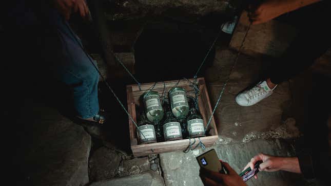 Vodka being lowered into spooky cellar
