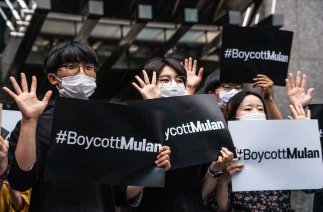 Photo of protesters holding up #boycottMulan signs