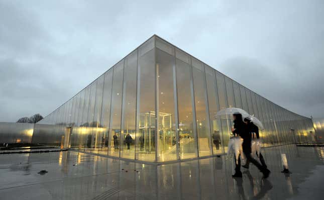 Visitors walk past Le Louvre Lens Museum.
