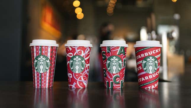 Four new Starbucks 2021 holiday cups with red festive designs