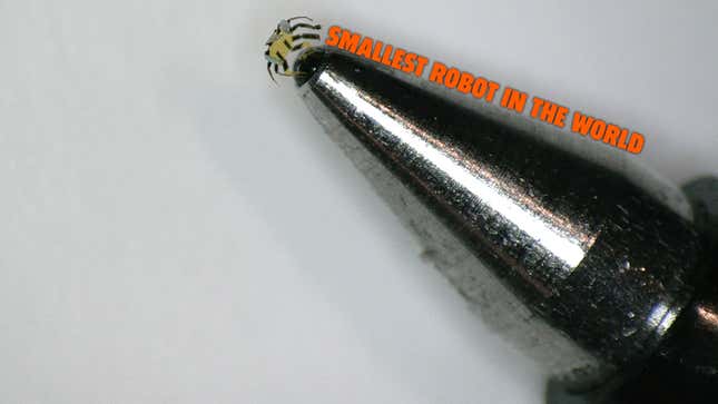 A photo of a tiny crab-like robot on the end of a pen with the caption "smallest robot in the word". 