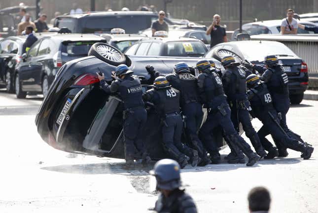 Image for article titled French taxi drivers rampage against Uber—burning tires, flipping cars, and inconveniencing Courtney Love