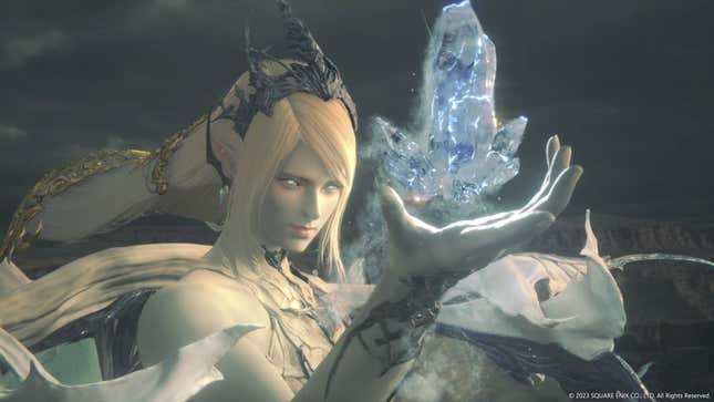 The Eikon Shiva appears in close-up, a pale woman with icy blue eyes, summoning a shard of ice in her open hand.